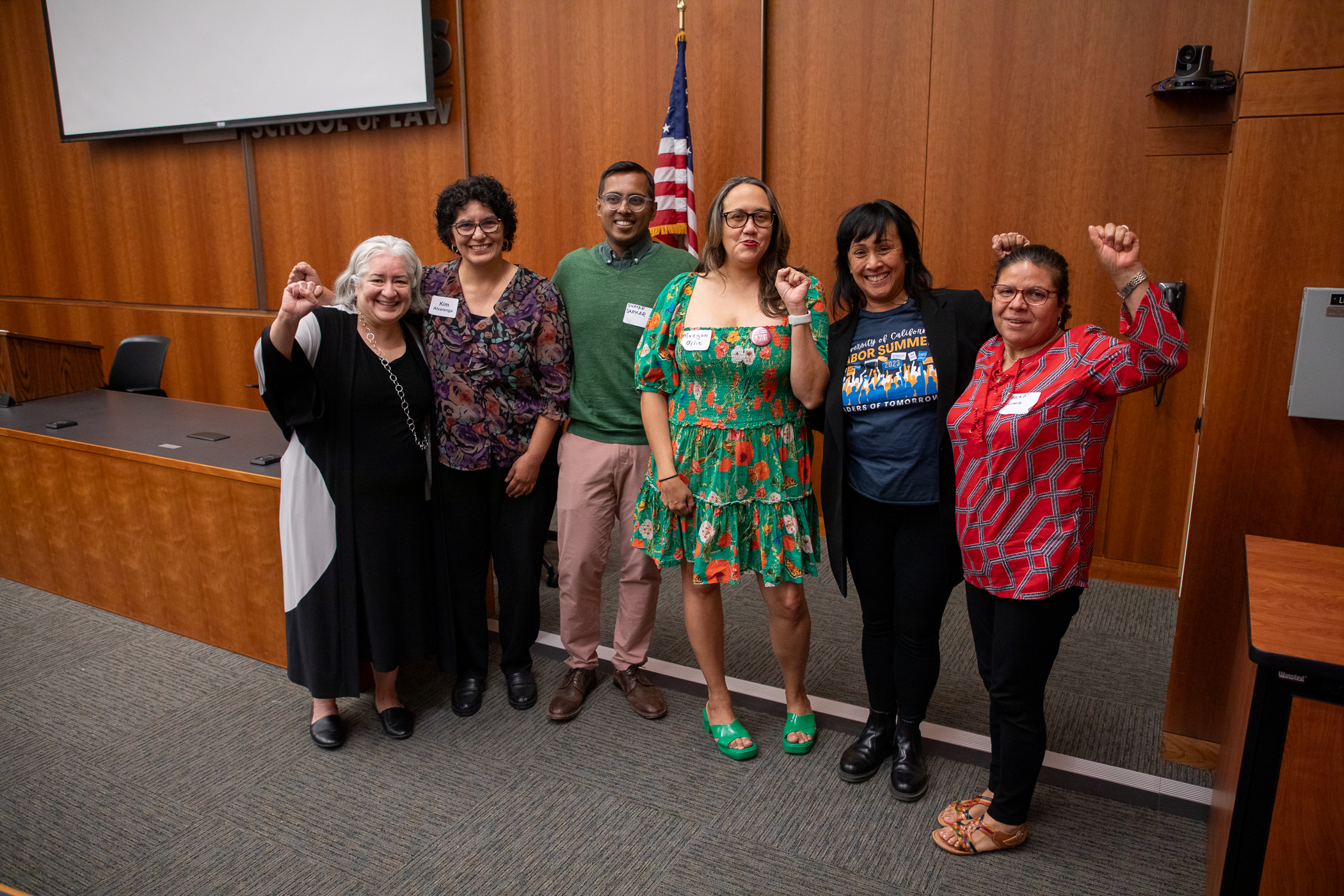 A group of people with their fists up in solidarity. 