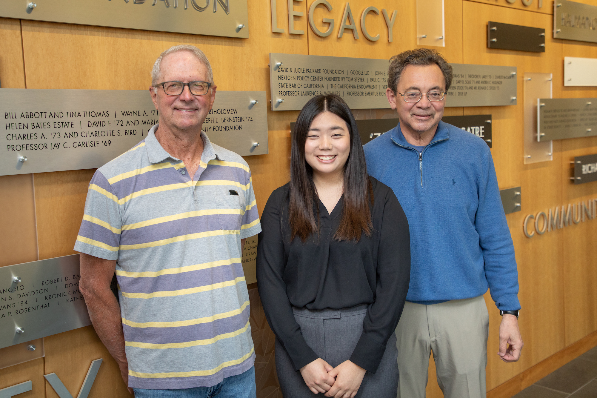 Photo of Bill Mantle '74, Karina Lee '24 and Dean Kevin R. Johnson.