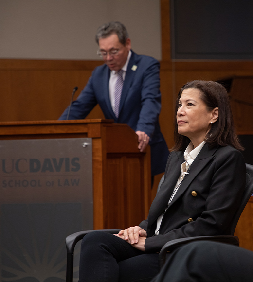 Dean Kevin Johnson speaking at the podium at King Hall at an event honoring Tani Cantil-Sakauye.