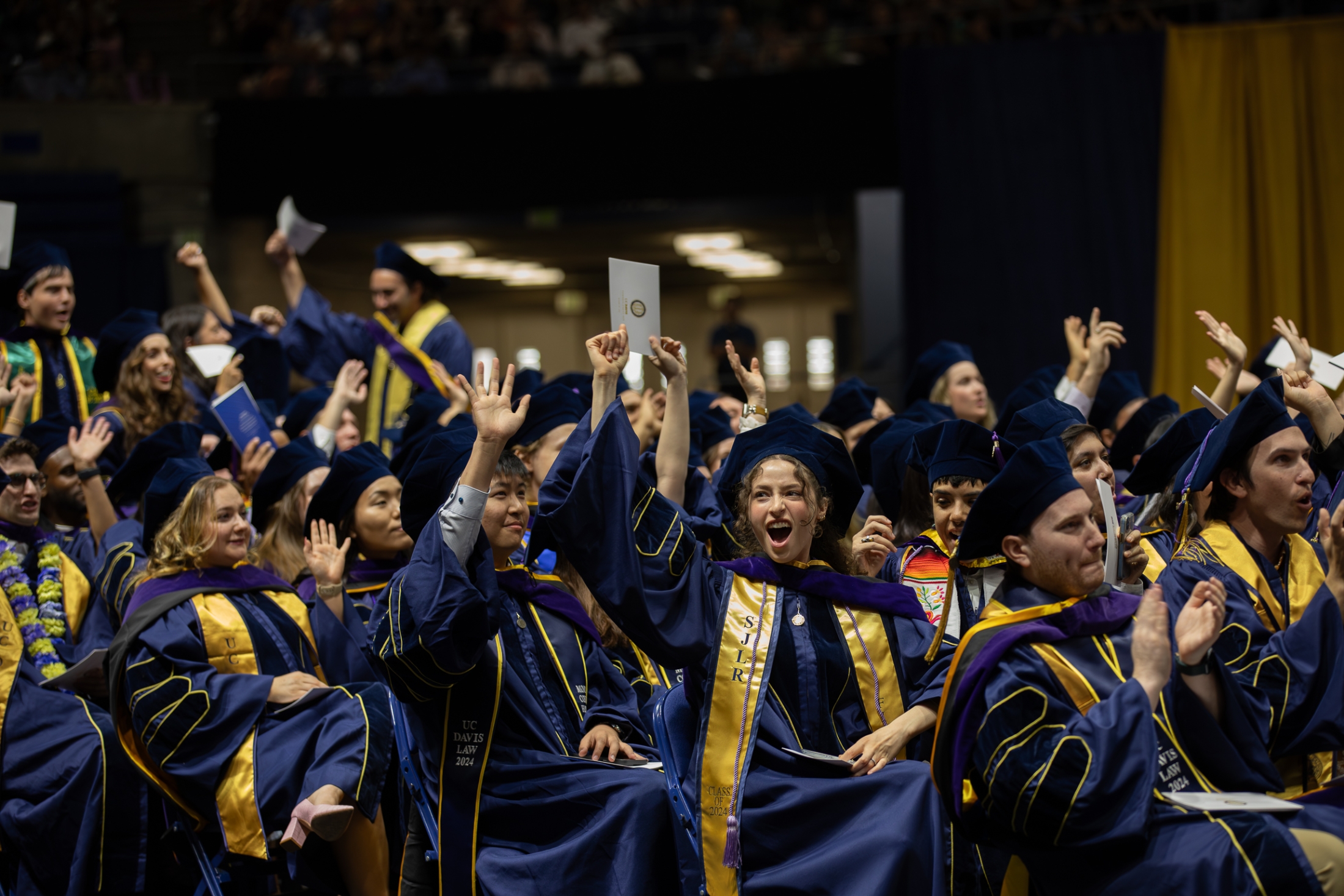 Smiling graduates at the Class of 2024 commencement ceremony.