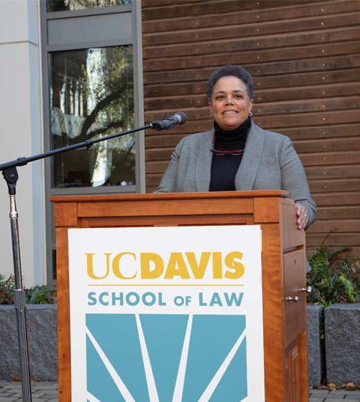 Justice Kelli Evans '94 speaking at the podium at UC Davis Law.