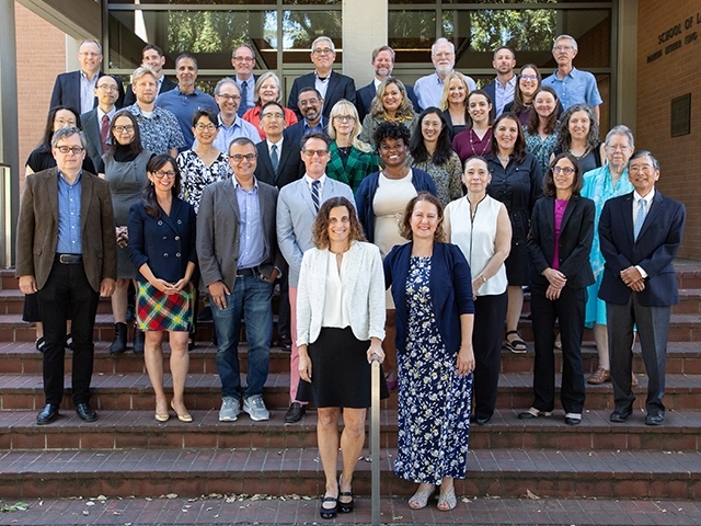 2024-25 UC Davis Law faculty members standing on the steps of King Hall.
