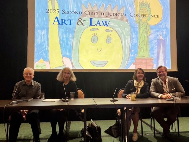 From left to right, Yale Law Professors Robert Post and Reva Siegel, Artists at Risk Connection Executive Director Julie Trébault and UC Davis Law Professor Brian Soucek. All individuals are sitting at a table with a blue and yellow illustration on a screen behind them.