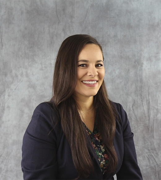 Laura Aranda wearing a black blouse and smiling at the camera.
