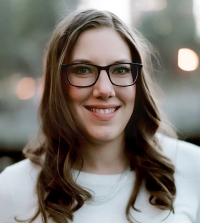 UC Davis Law Lecturer Nina Jehle wearing glasses and smiling at the camera.
